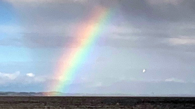 Bright rainbow over ocean for writer's diary
