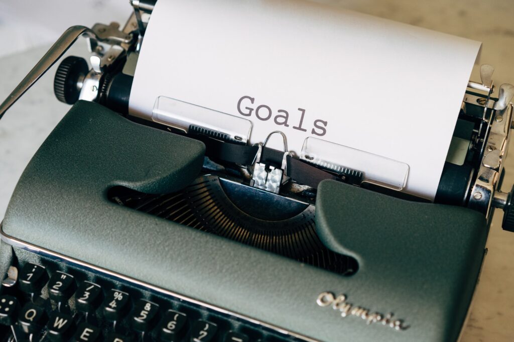 Typewriter with goals written on sheet of paper - Photo by Markus Winkler on Unsplash