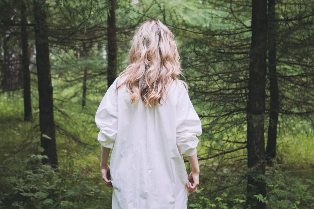 Nightdress girl in the woods - Photo by Max Lakutin on Unsplash