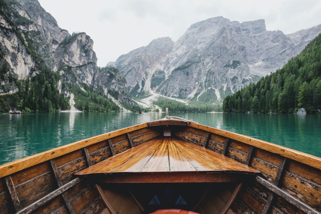 Travel writing - boat on open water - Photo by Luca Bravo on Unsplash