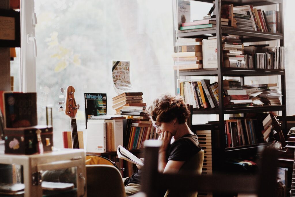 woman reading in music bookstore - Photo by Hatice Yardım on Unsplash