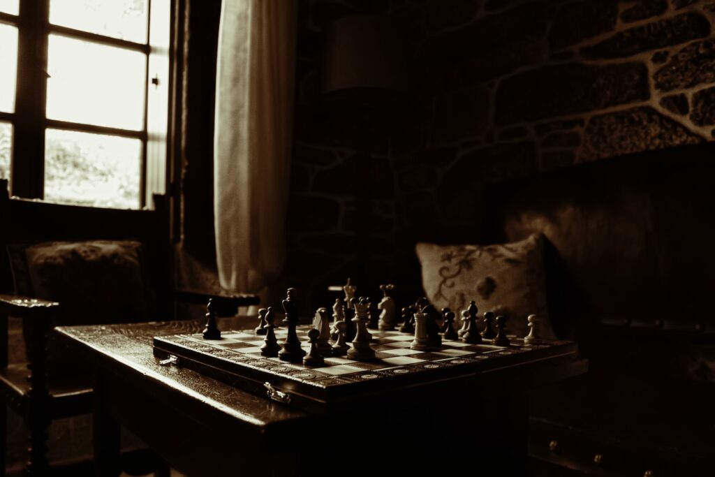 Chessboard on table - Dark Academia Aesthetic - Photo by Javier Grixo on Unsplash