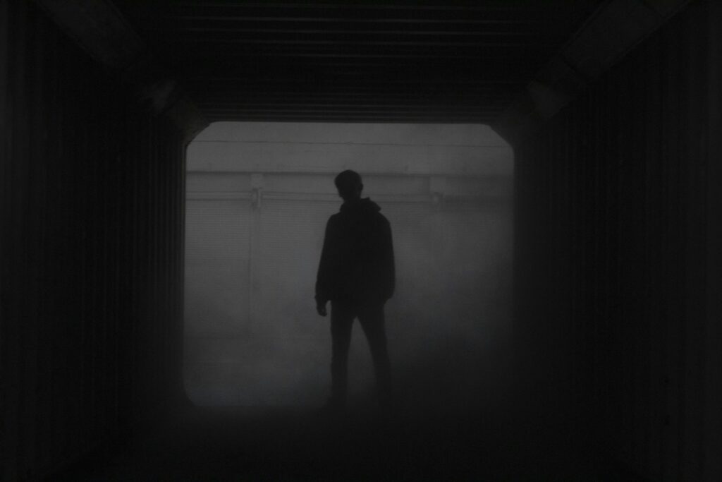 Shadowy figure in a mystery or crime thriller - Photo by ALEXANDRE LALLEMAND on Unsplash